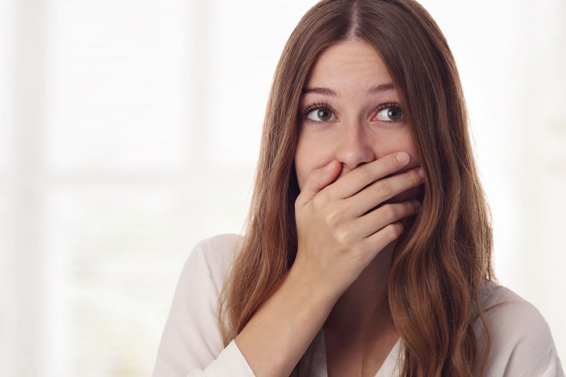 dental patient hiding smile
