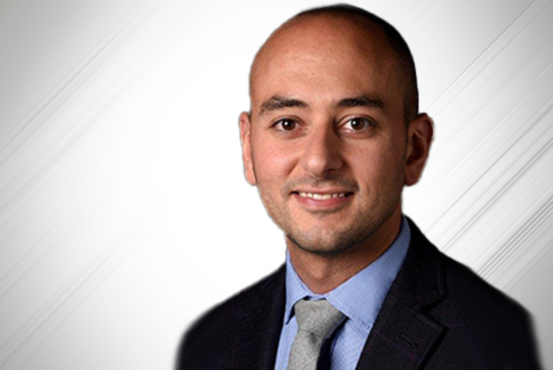 Professional headshot of Dr. Salem, dental implant specialist in formal attire